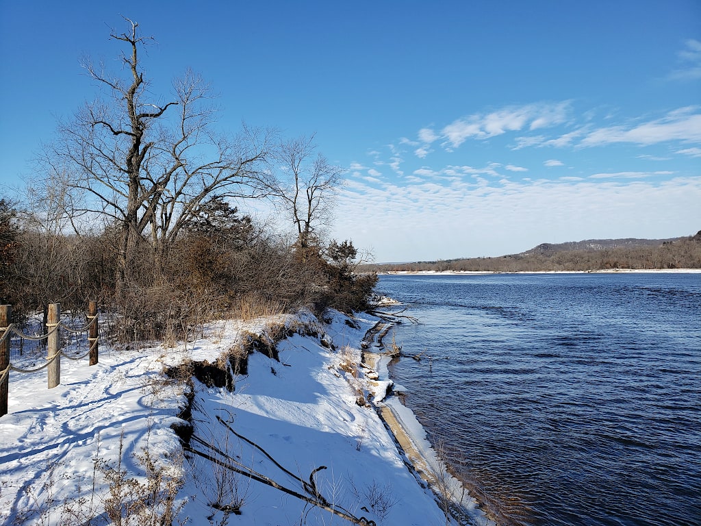 View of the Wisconsin River with a small snow covered bluff along the shore.