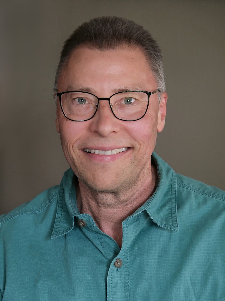 Head shot of Jonathan Bloy looking at the camera and smiling.