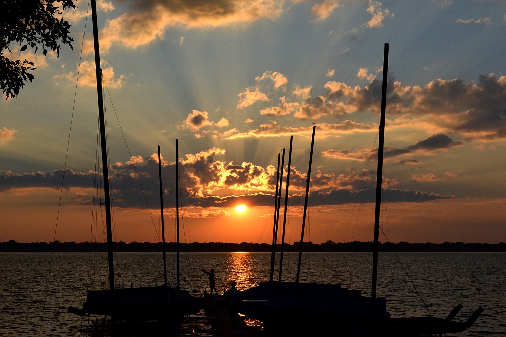 sunbeams sunset at a sailboat dock