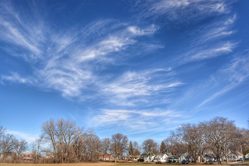 Cirrus clouds in the sky above a neighborhood