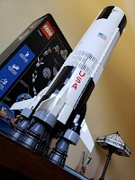 Lego pieces form complete the first stage of a Saturn V rocket