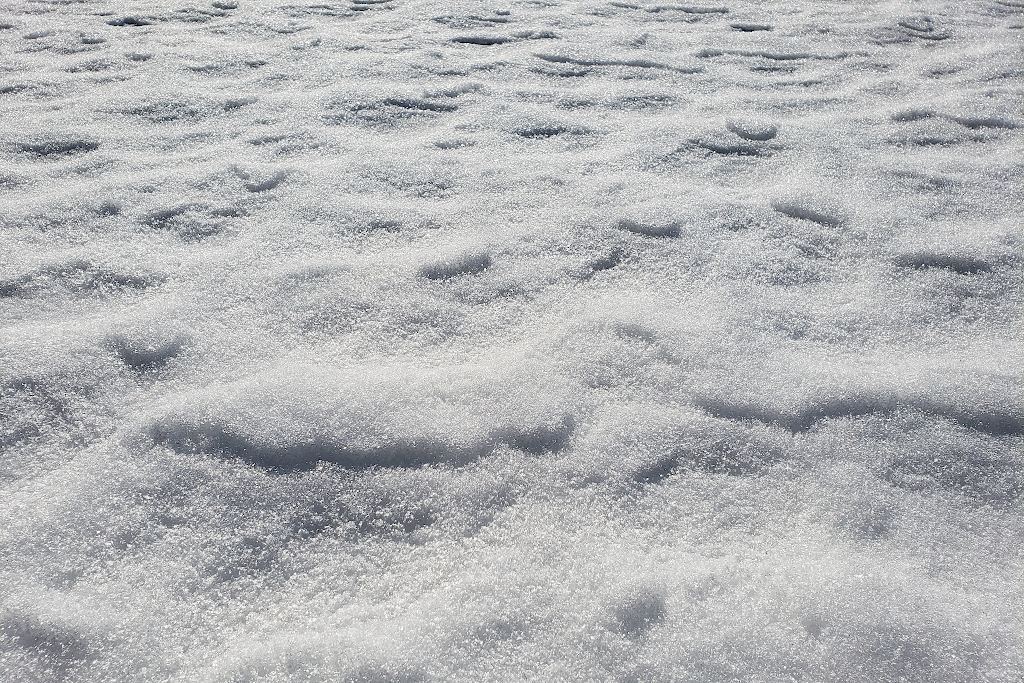Several small ridges of snow on the ground