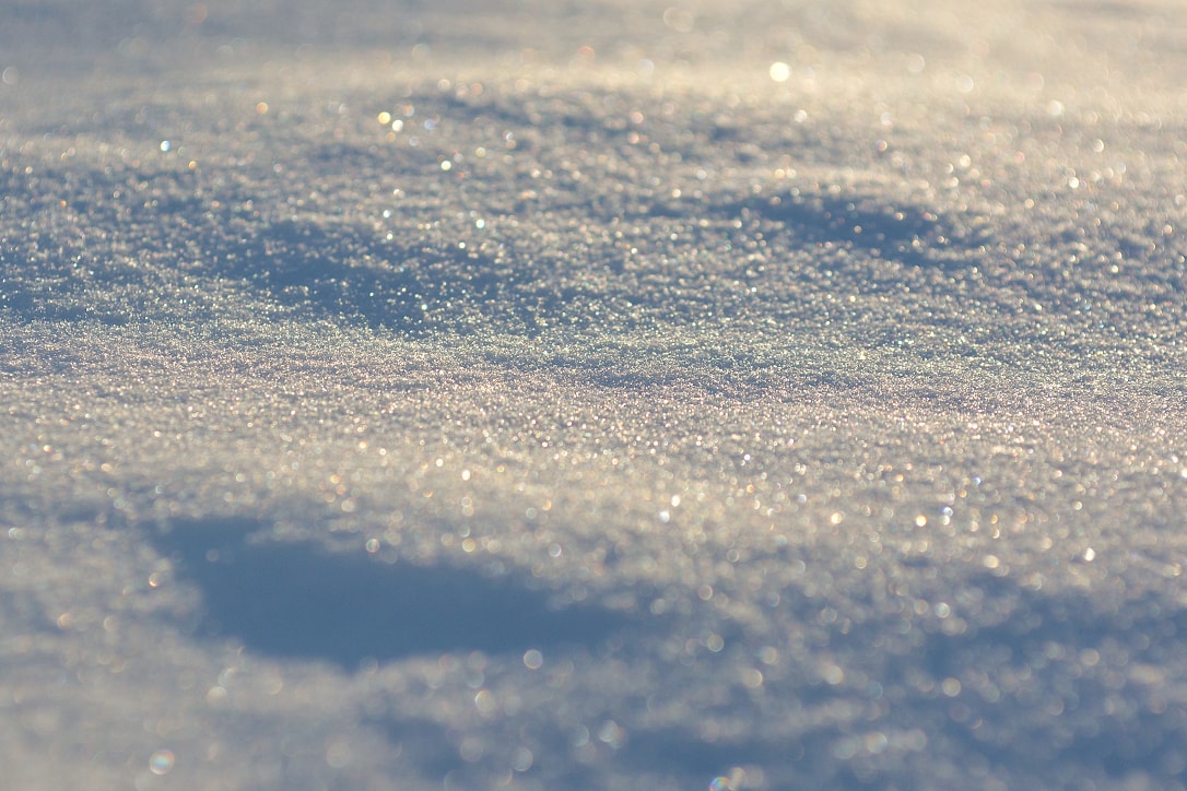 Close up of freshly fallen snow, sparkling in the sunlight.